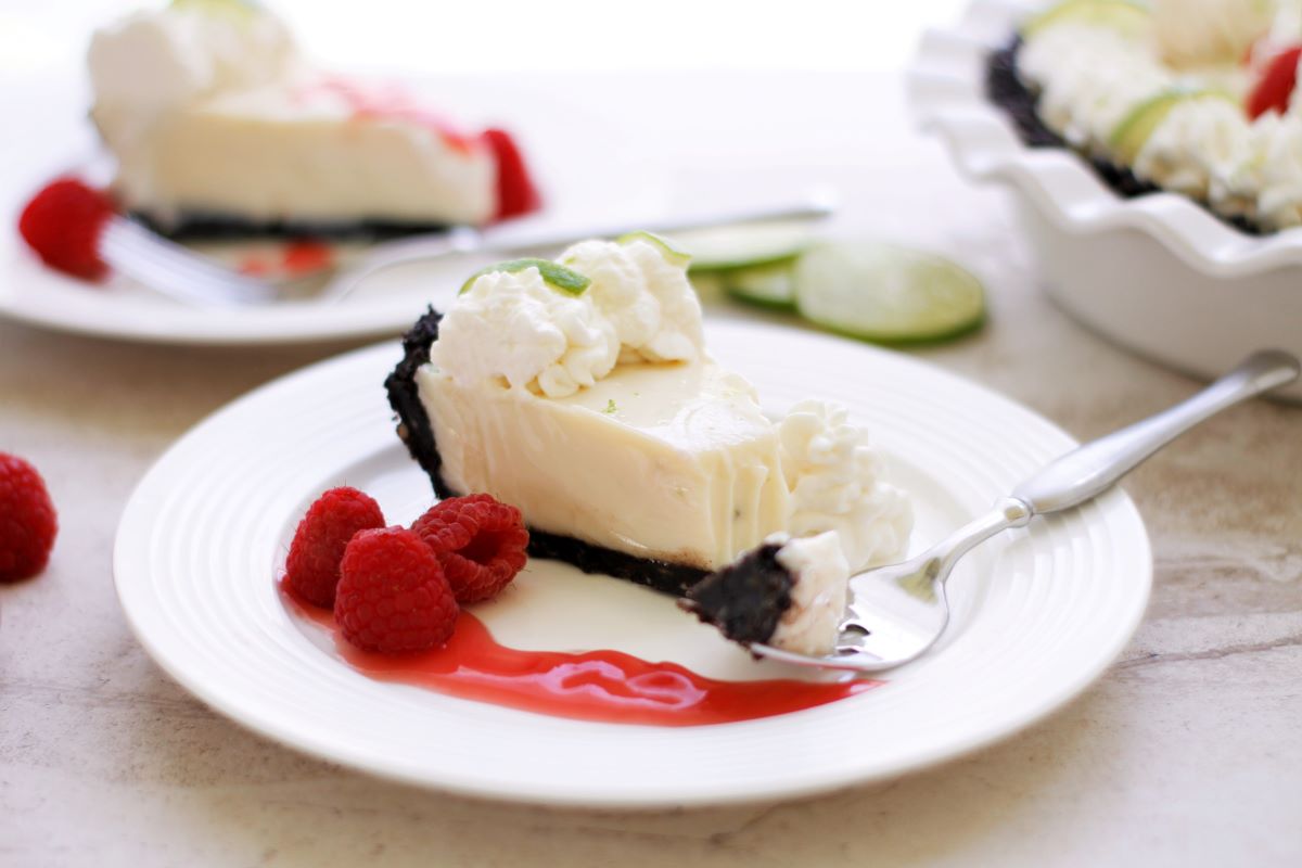 A slice of key lime pie with chocolate crust