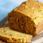 A loaf of pumpkin bread with raisins and walnuts