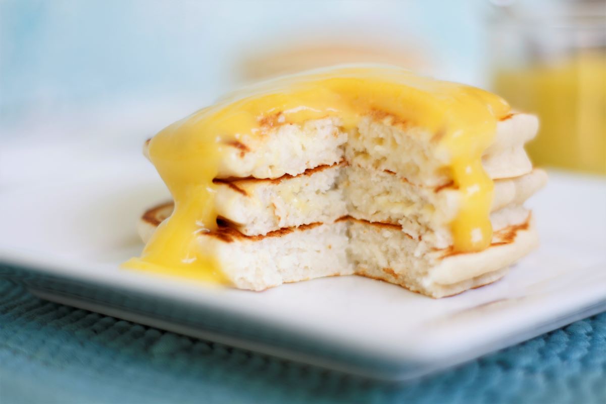 a stack of pancakes with lemon curd on top
