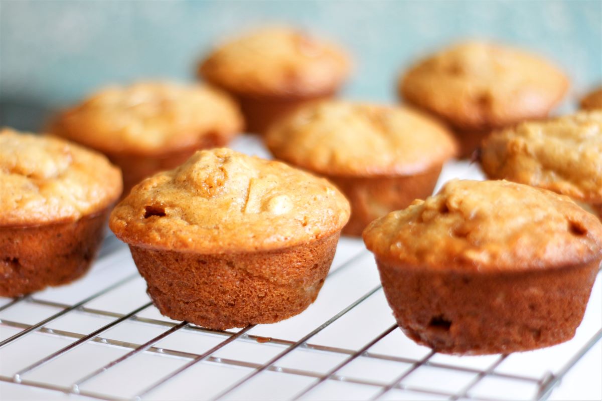 A cooling rack with caramel apple muffins cooling. 