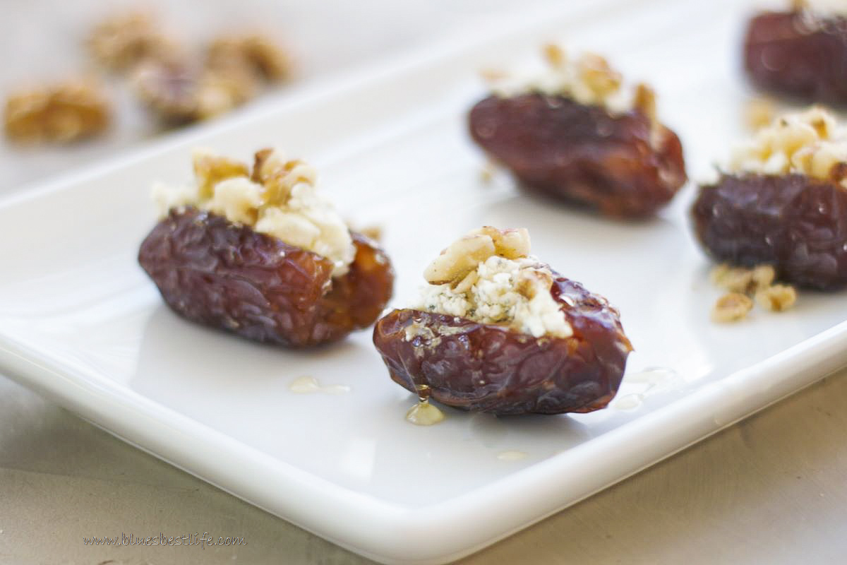 A platter with blue cheese stuffed dates drizzled with honey. 