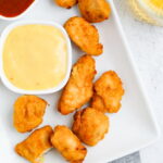Chicken nuggets on a plater with dipping sauce