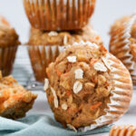 banana carrot muffins on the counter with honey