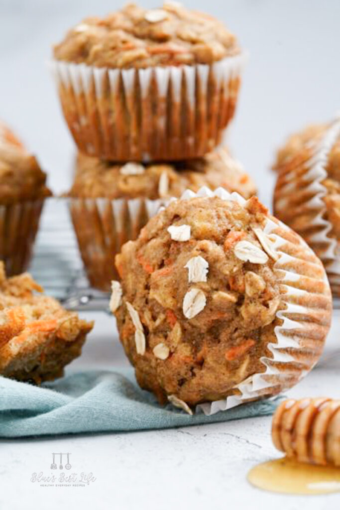 banana carrot muffins on the counter with honey