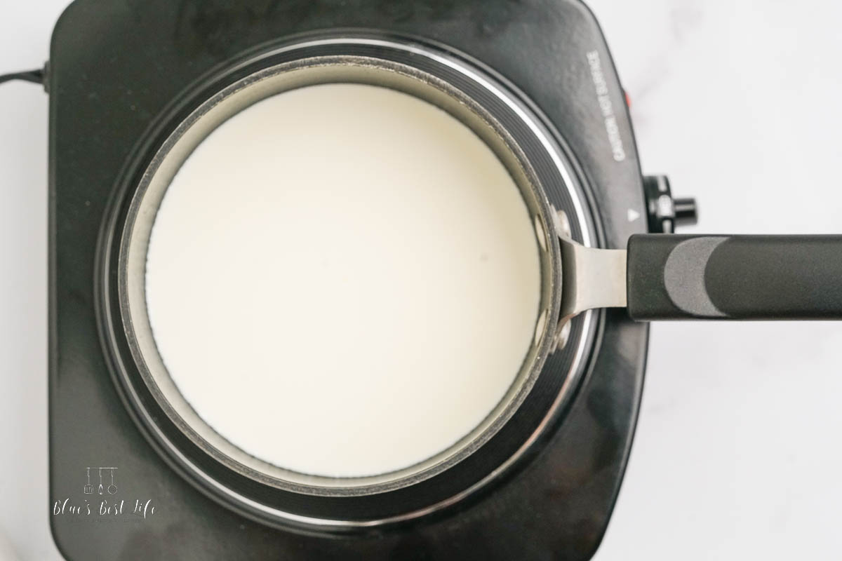 The cream simmering on a stove top