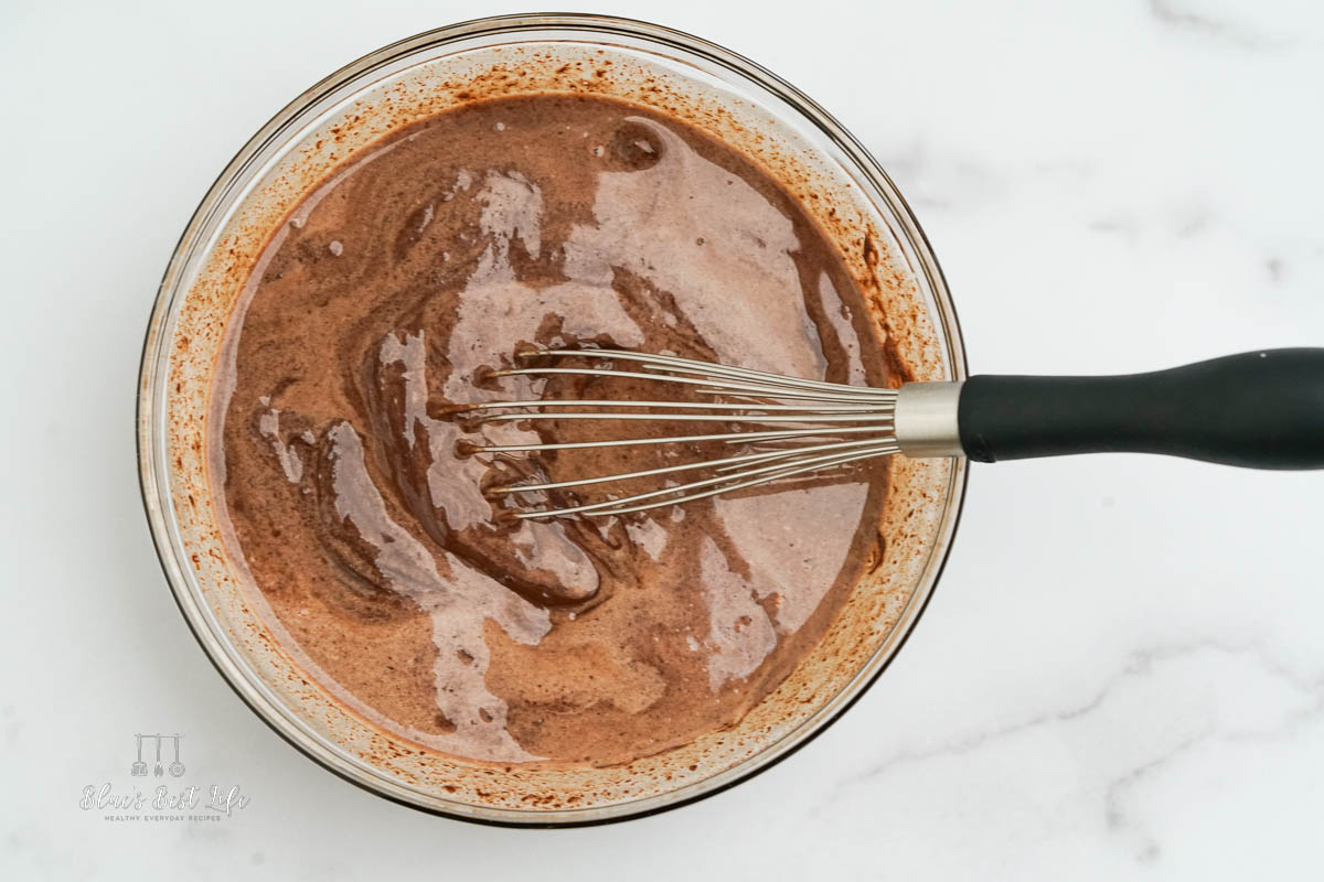 Whisking melted chocolate and cream together