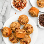 mini banana muffins on a plate with pecans and chocolate chips