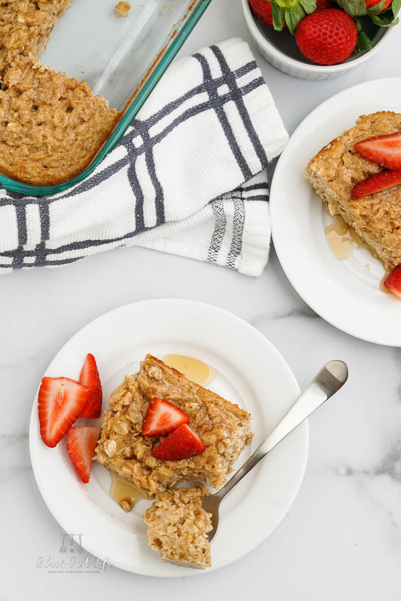 baked oatmeal on a plate with strawberries.