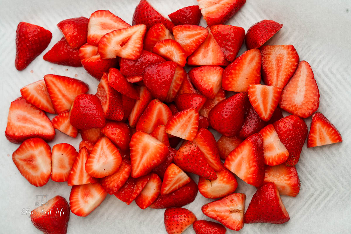 Strawberries on a rimmed baking pan.