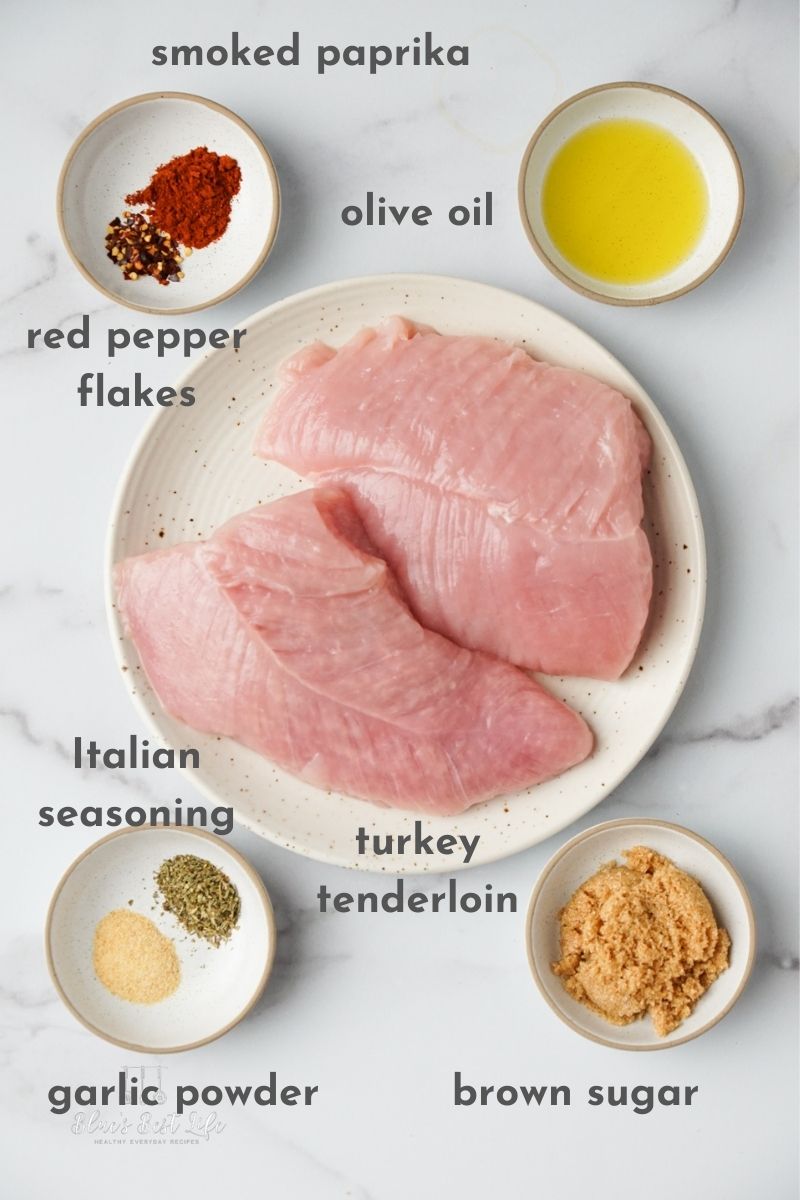 Ingredients for air fryer turkey tenderloin: red pepper flakes, smoked paprika, olive oil, Italian seasoning, garlic powder and brown sugar. 