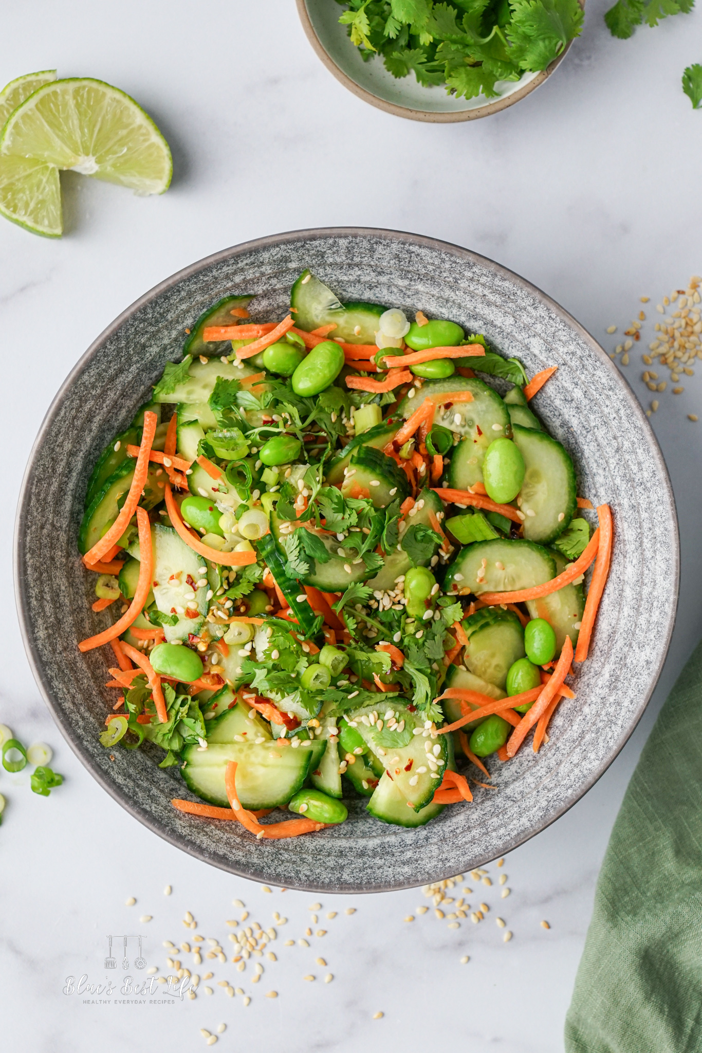A bowl with cucumber carrot salad.