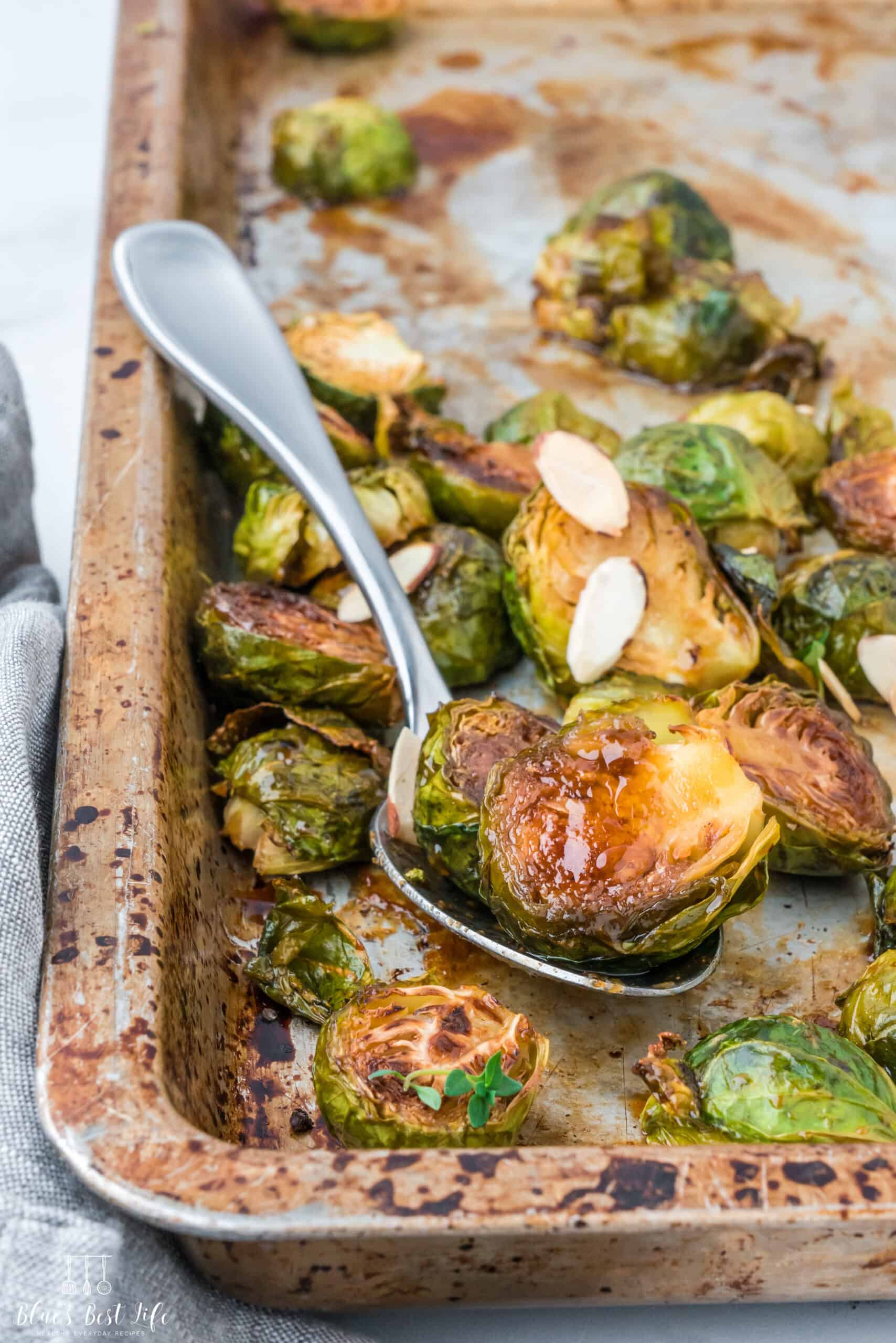 A close up of the brussels sprouts roasted on a sheet pan.