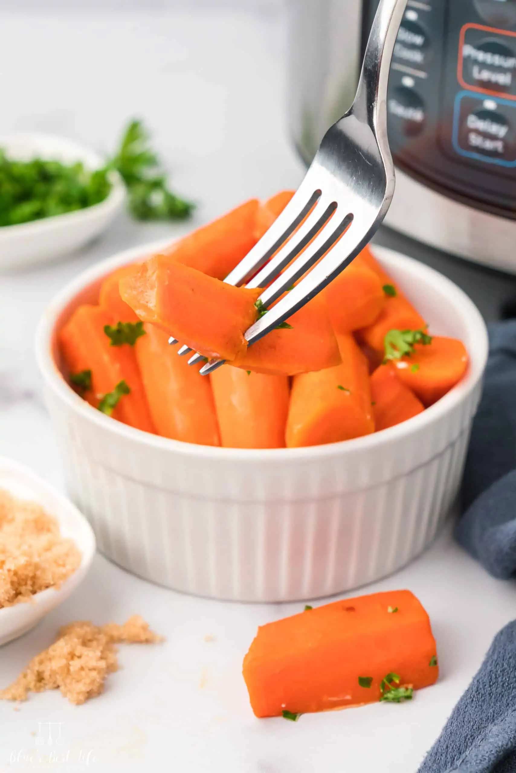 A bowl with steamed carrots. 