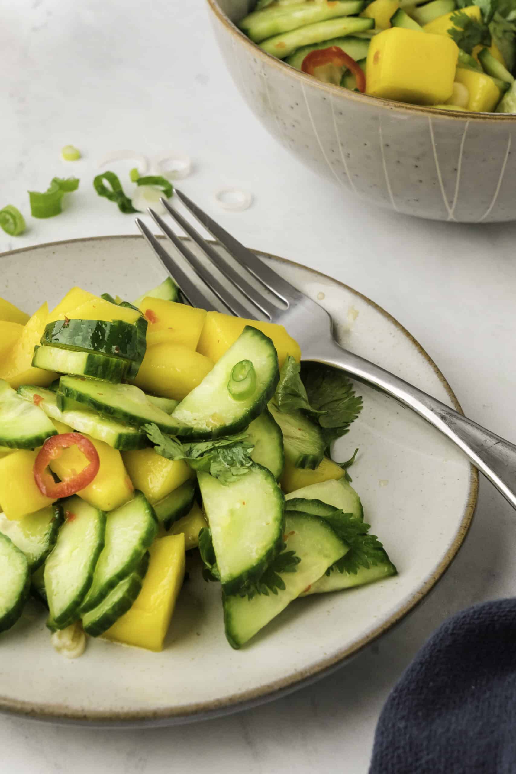 Mango salad on a plate with a fork. 
