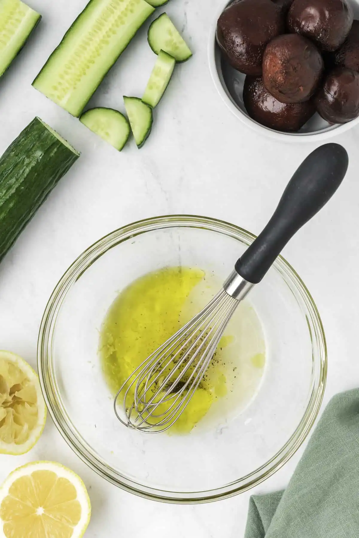 The salad dressing whisked in a bowl. 