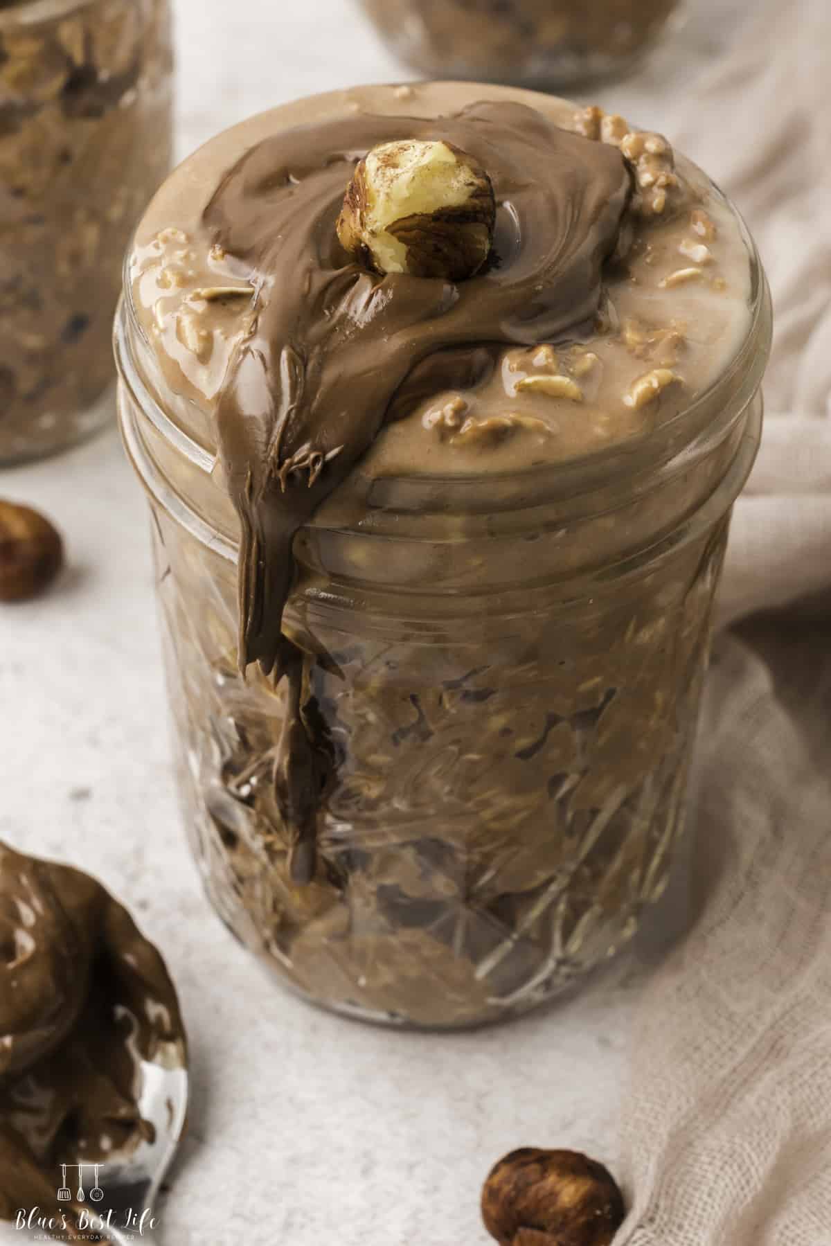 Three servings of Nutella overnight oats in mason jars. 
