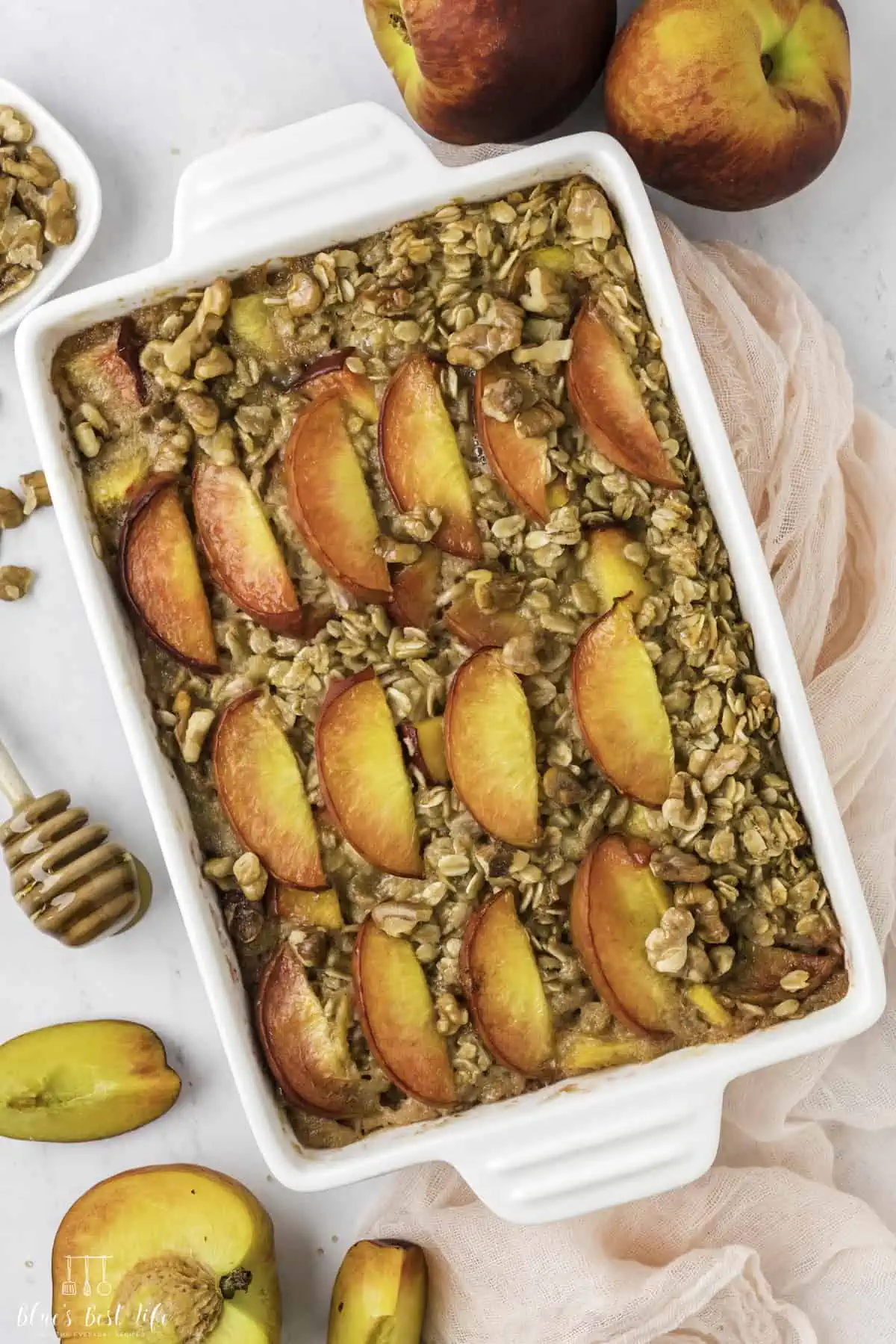 A casserole dish with peach baked oatmeal. 