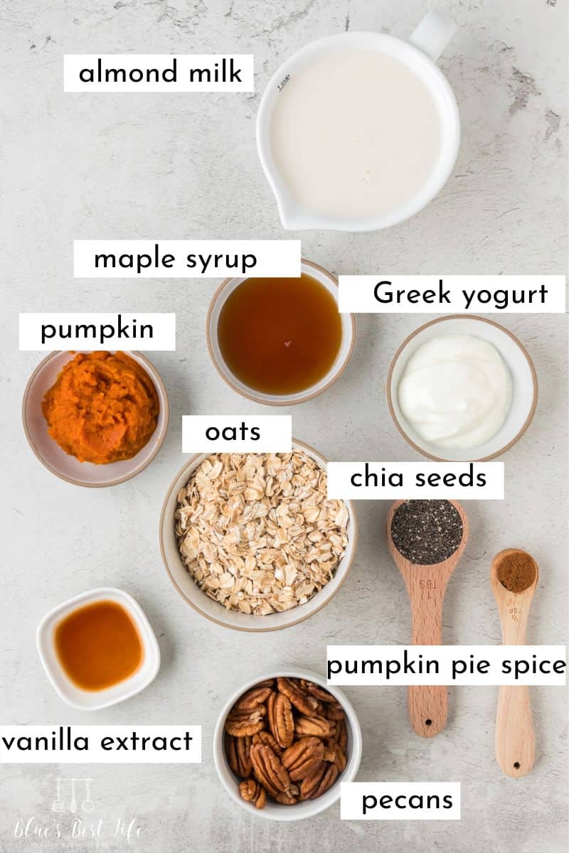Ingredients to make pumpkin overnight oats: Almond Milk, Maple Syrup, Pumpkin, Greek Yogurt, oats, chia seeds, pumpkin spice, pecans, vanilla extract. 
