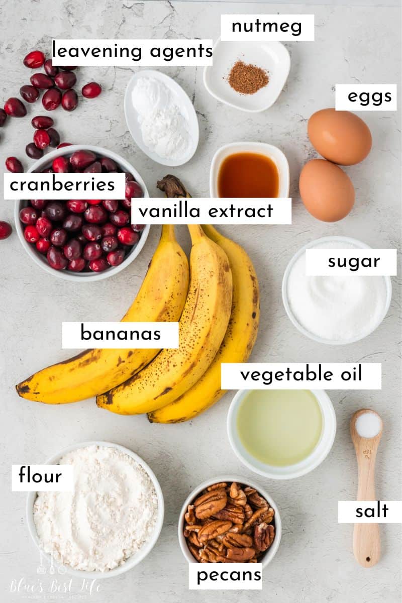 The ingredients needed to make cranberry banana nut bread: nutmeg, leavening agents, eggs, cranberries, vanilla extract, bananas, sugar, vegetable oil, flour, pecans, & salt. 