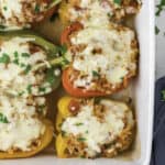 Chicken stuffed peppers in a casserole dish.