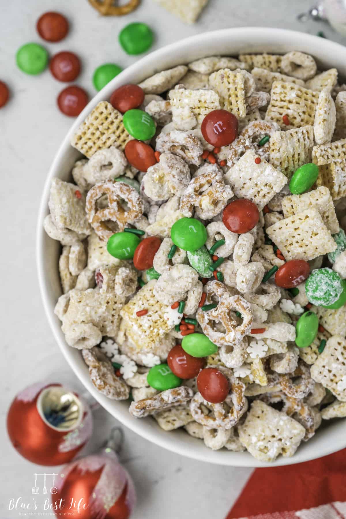 A bowl of Christmas Chex mix with M&M's. 