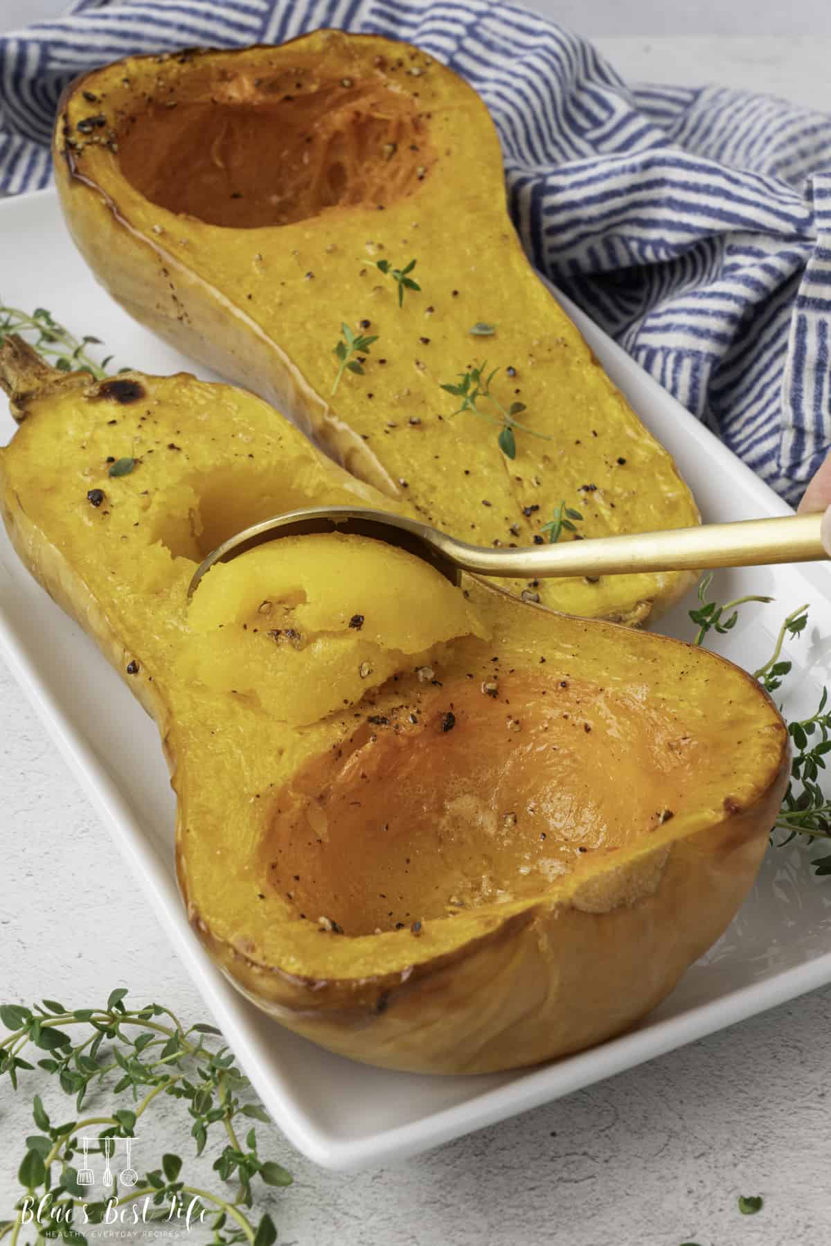 A spoon scooping out the roasted butternut squash. 