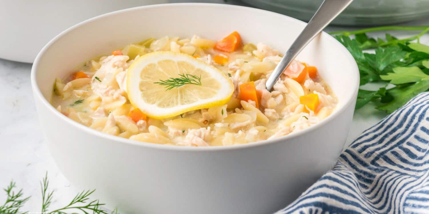 A bowl of Creamy Lemon Chicken Orzo Soup.