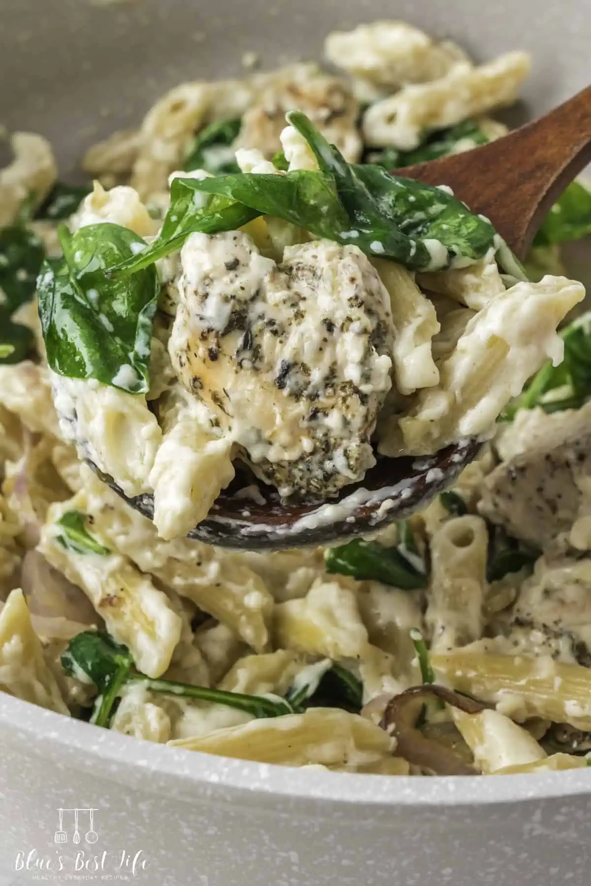 A spoonful of the chicken spinach pasta. 