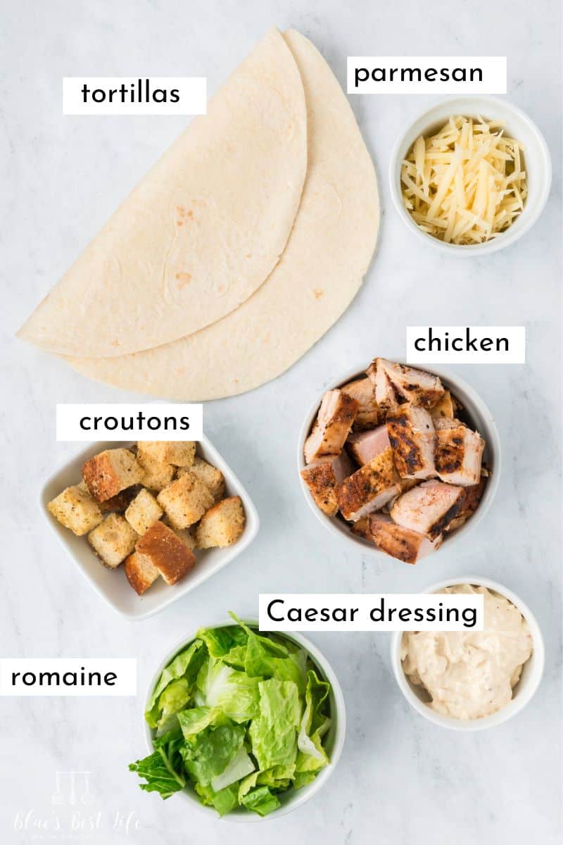 Ingredients for the Chicken Caesar Salad Wraps: parmesan, tortillas, croutons, cooked chicken chunks, romaine lettuce, Caesar Dressing. 