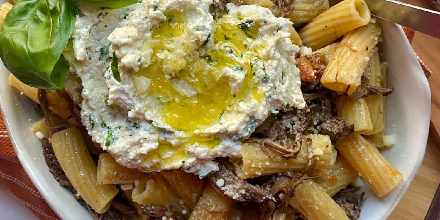 A close-up shot of Shredded Beef Brisket served in a bowl. 