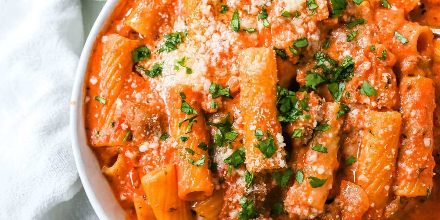 Pasta with fresh herbs on a bowl.