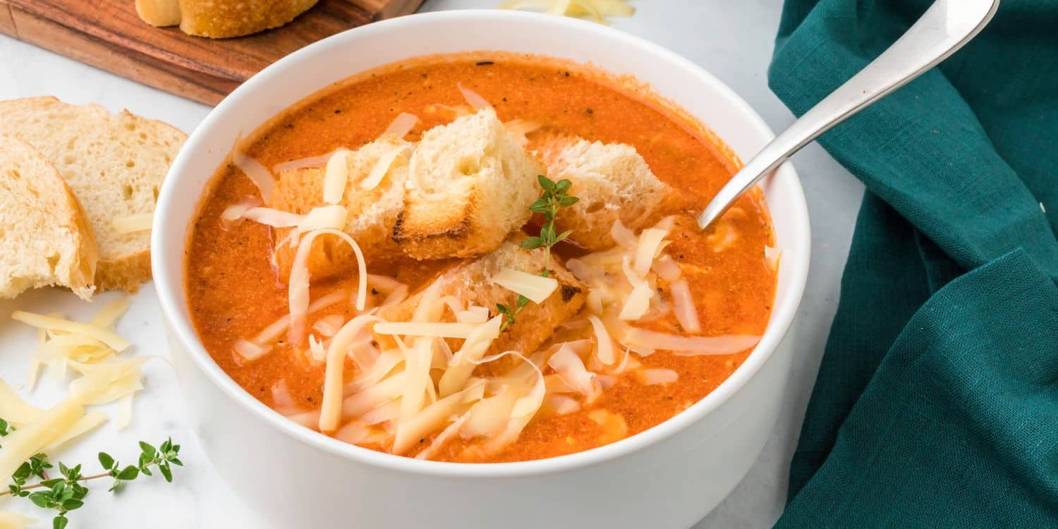 A bowl of Roasted Red Pepper Smoked Gouda Soup.