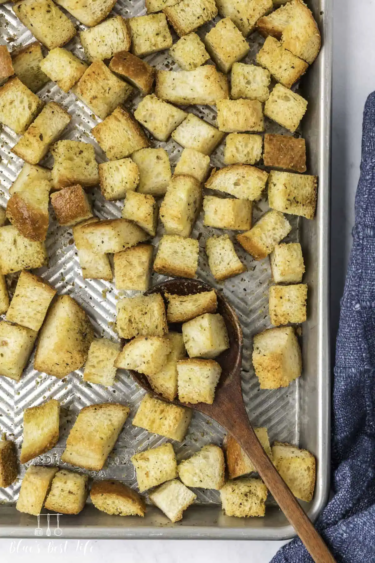 A baking tray with homemade croutons. 