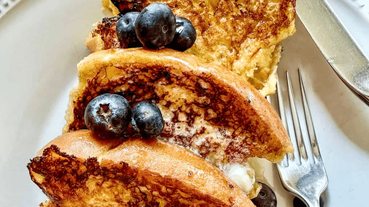 three pieces of french toast with fresh blueberries