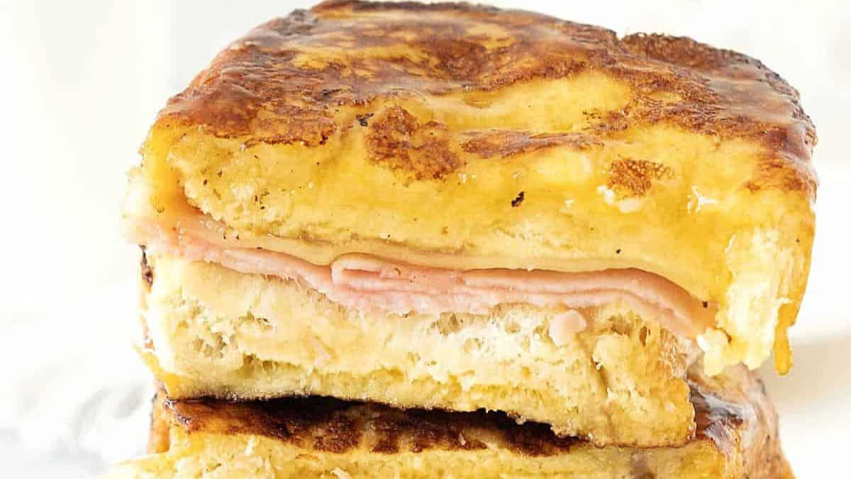 stacked and cut in half ham and cheese french toast sandwiches