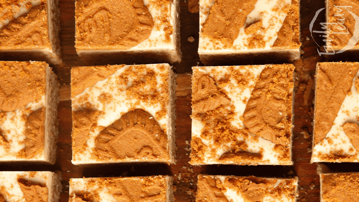 Rice Krispie Treats topped with biscoff frosting and cookies