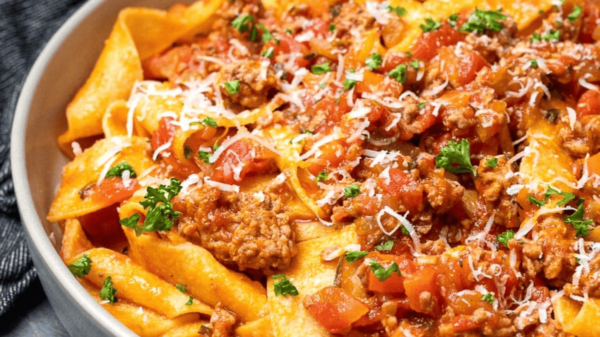 a bowl with pappardelle and ragu made with ground pork and tomatoes