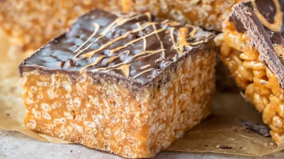 a square piece of Butterscotch Rice Krispie Treats with melted chocolate on top