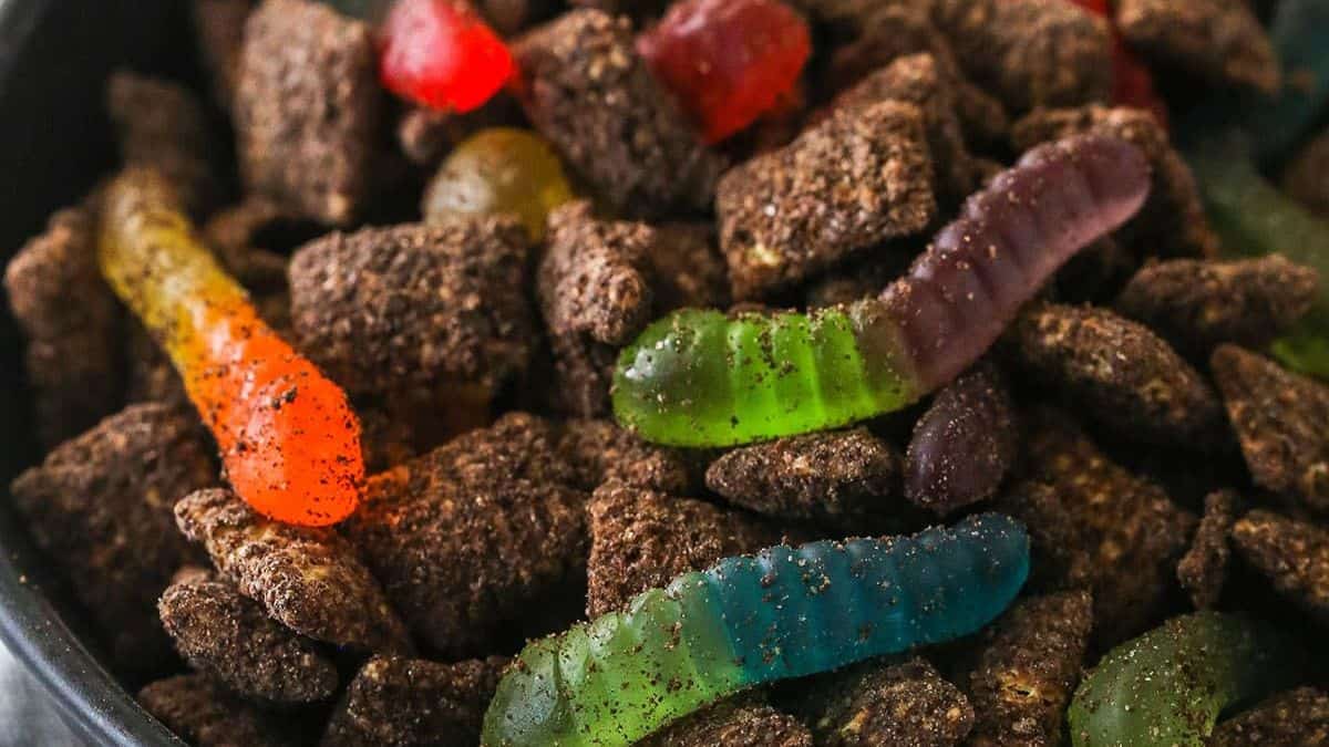 close up of a bowl of puppy chow with chocolate and gummy worms