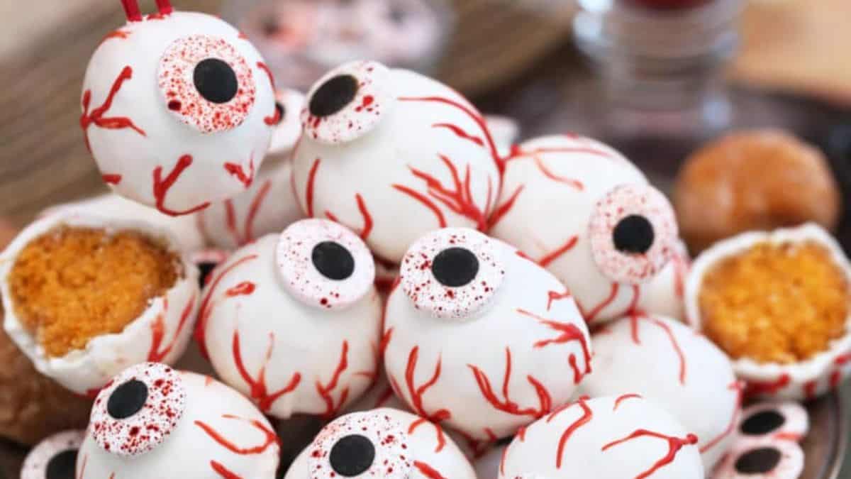 pile of donut eyeballs with halloween decorations and googly eyes