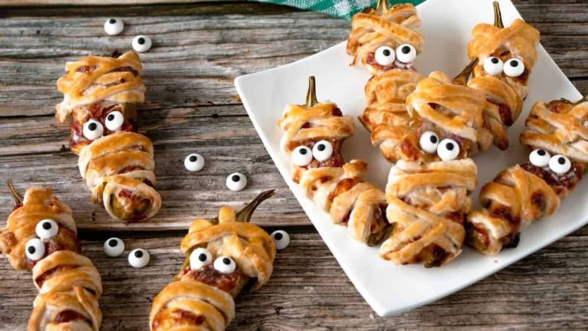 jalapeno poppers wrapped in puff pastry strips like mummies with googly eyes attached