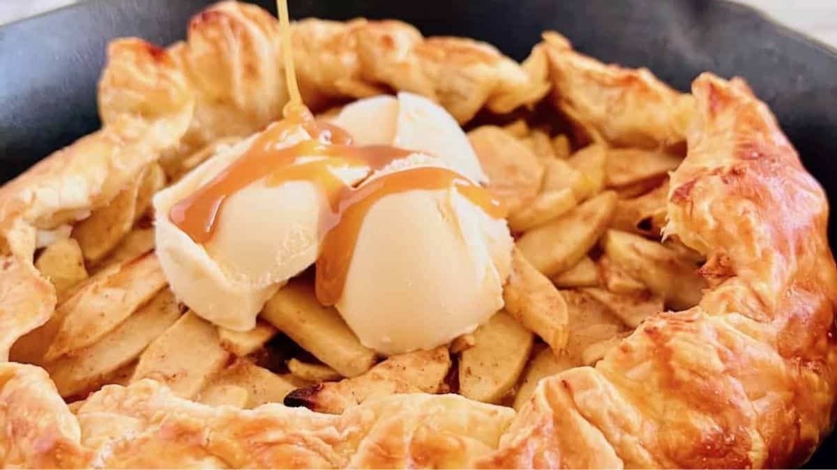 skillet with puff pastry galette with fresh apples. vanilla ice crea, and caramel drizzle on top