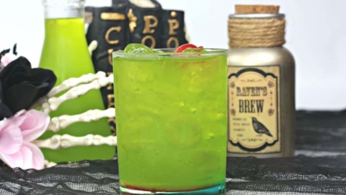 green cocktail in a glass with ice