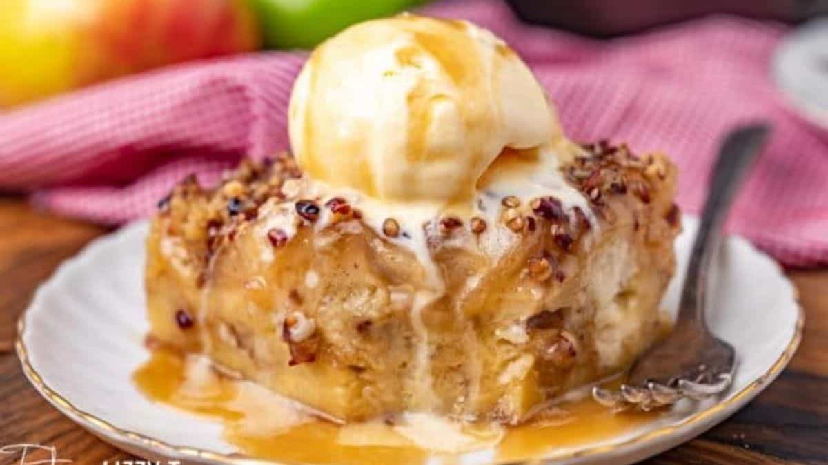a slice of Caramel Apple Bread Pudding served with vanilla ice cream