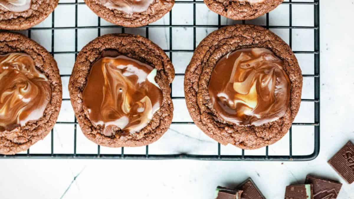 several large baked cookies with melted andes mint cookies as topping