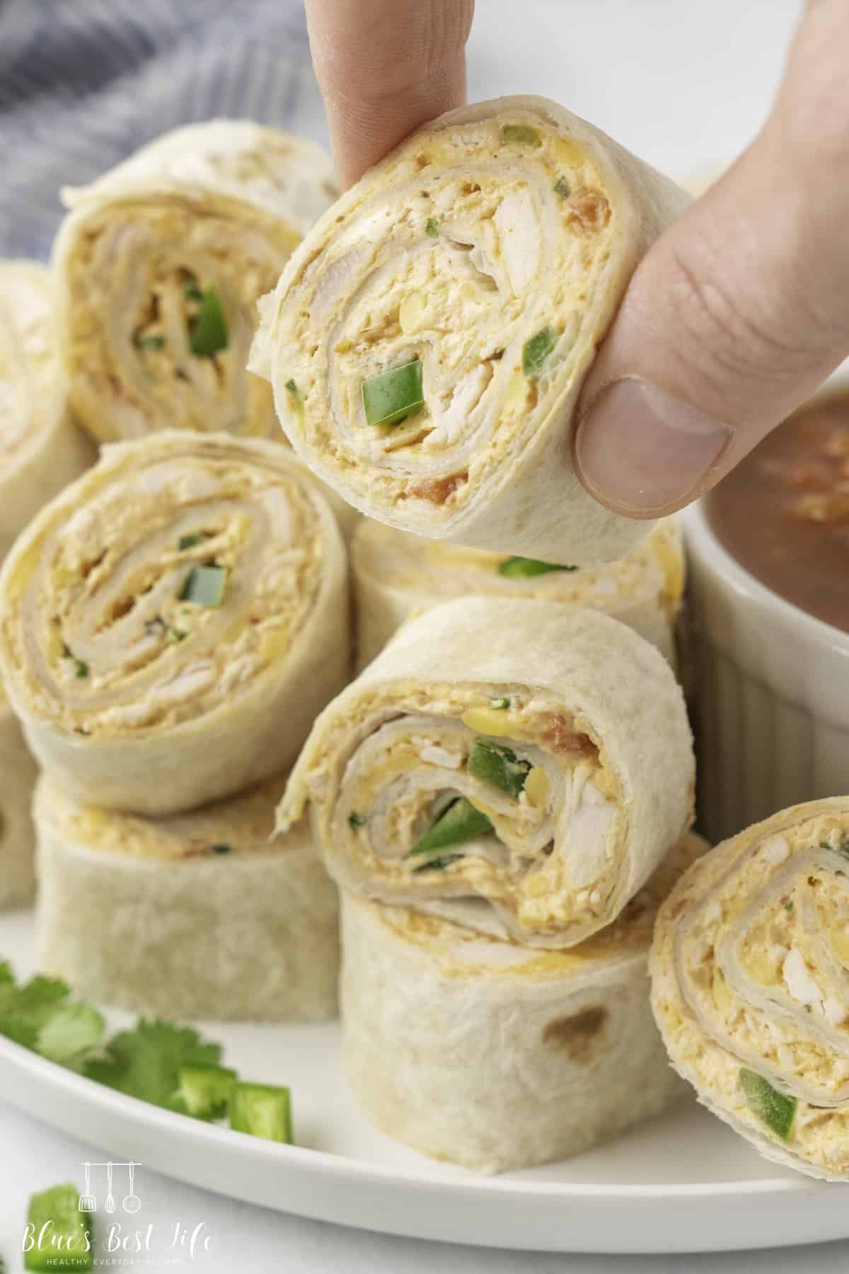 Holding a pinwheel sandwich.