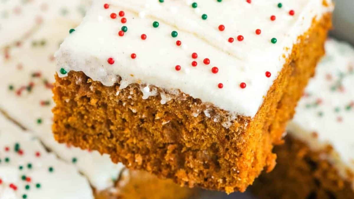 gingerbread sheet cake slice with cream cheese frosting and colorful sprinkles