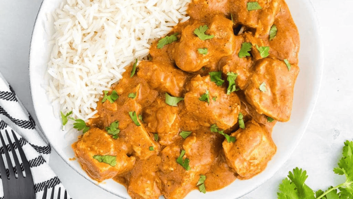 A plate of slow cooker butter chicken with rice.