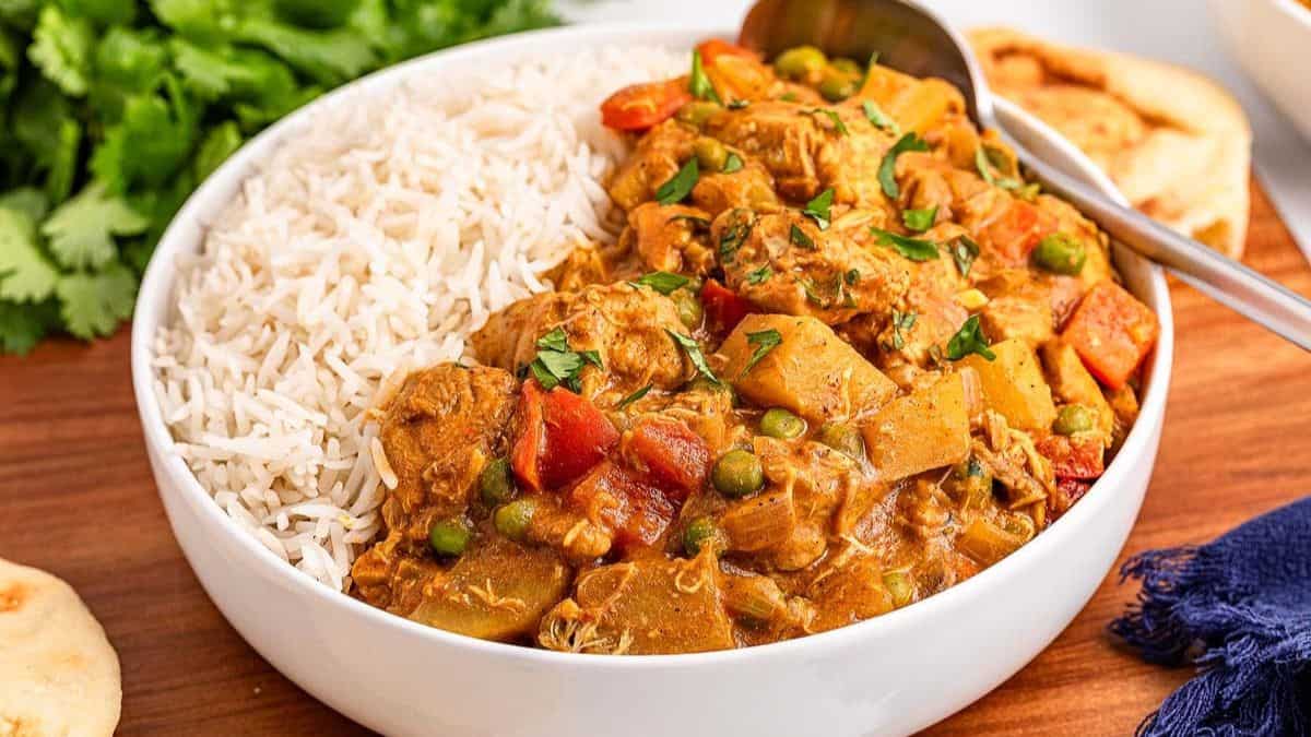 A bowl of slow cooker chicken curry with rice.
