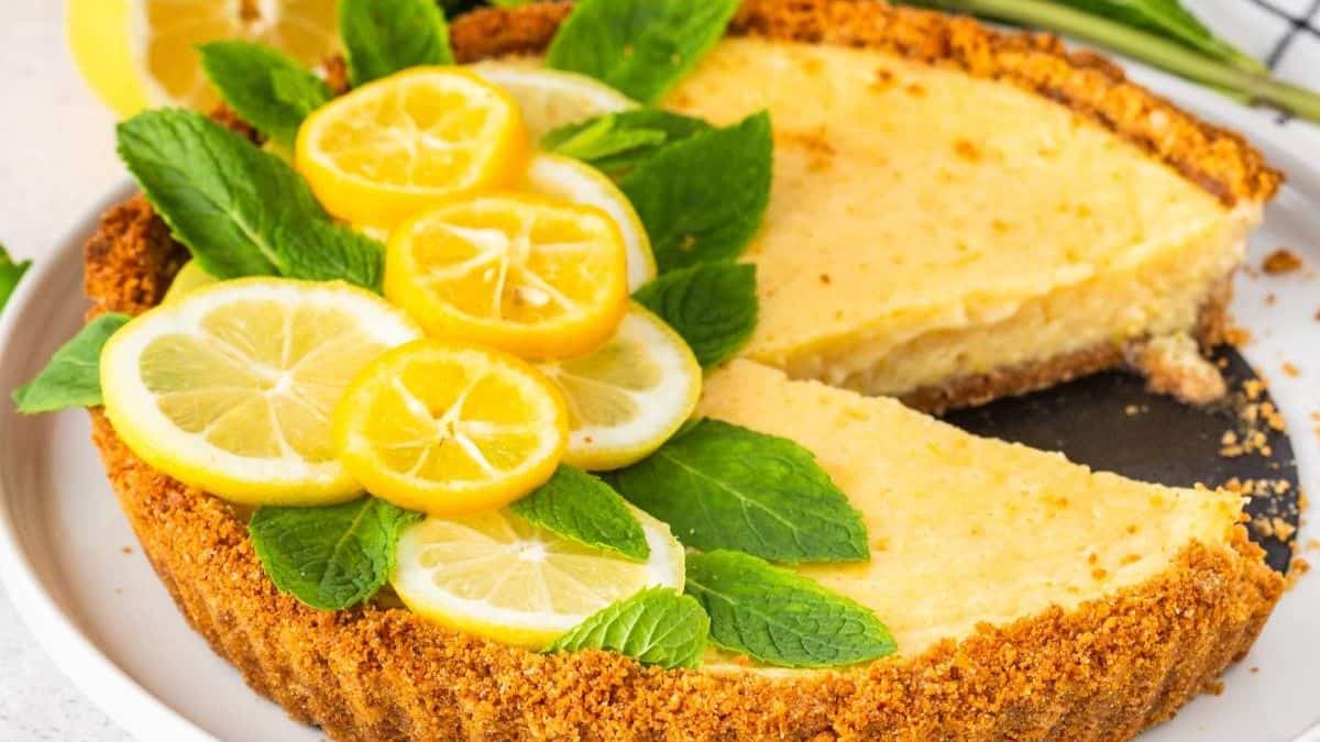 Beautifully plated lemon tart with missing slice.